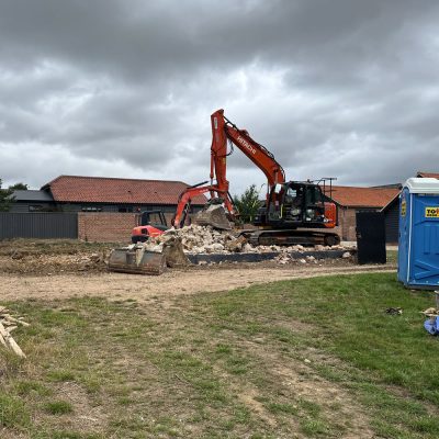 Breaking up concrete slab and foundations during demolition work in Cockfield
