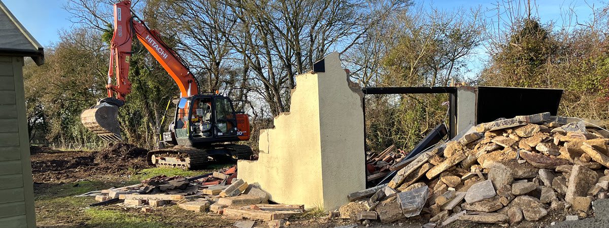 Demolition contractor carrying out controlled building demolition - Bury St Edmunds, Suffolk