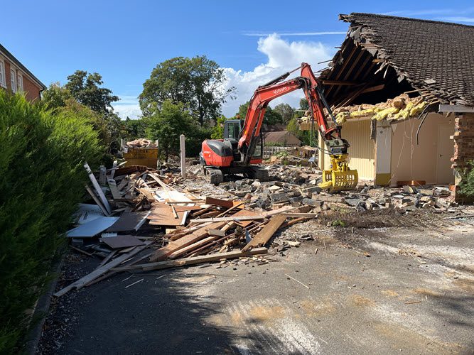 Demolition contractor carrying out controlled building demolition in Great Shelford Cambridge