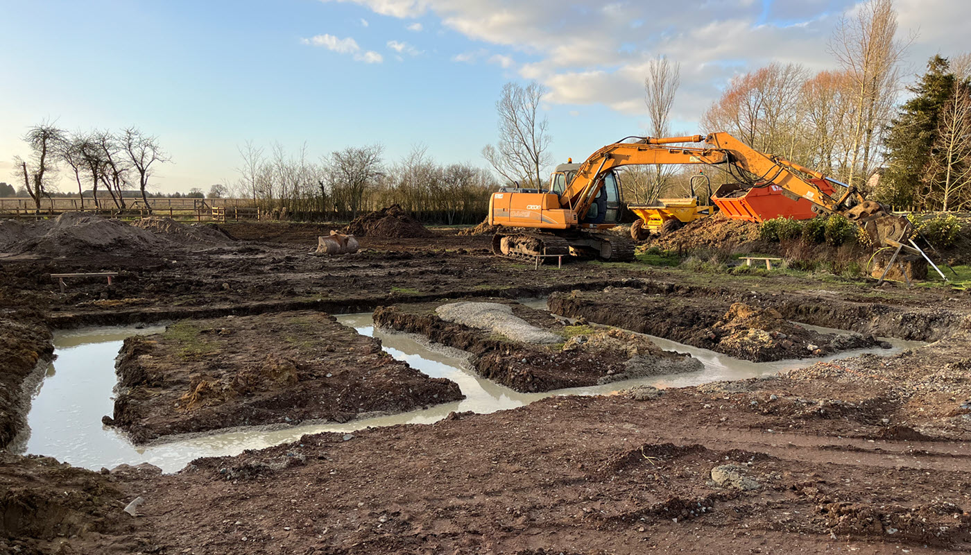 Groundworks contractor preparing foundations on a building site in Suffolk